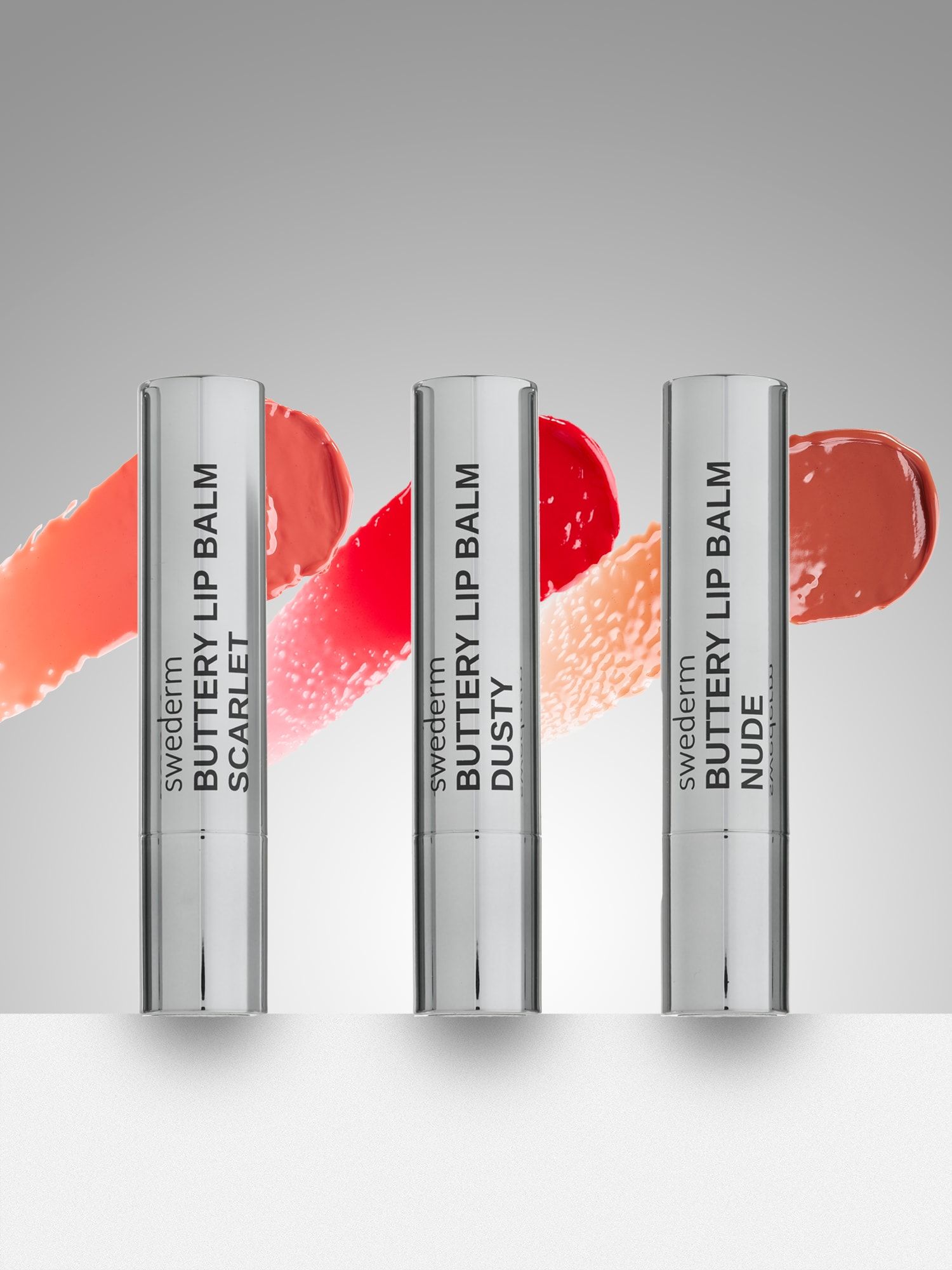 Trzy pomadki Buttery Lip Balm w odcieniach scarlet, dusty i nude
